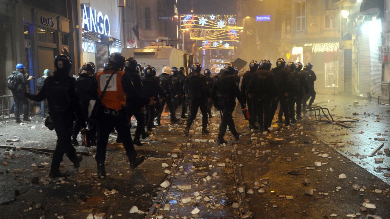 Turkish riot police patrol Istiklal Avenue in Istanbul amid clashes with protesters on December 27.