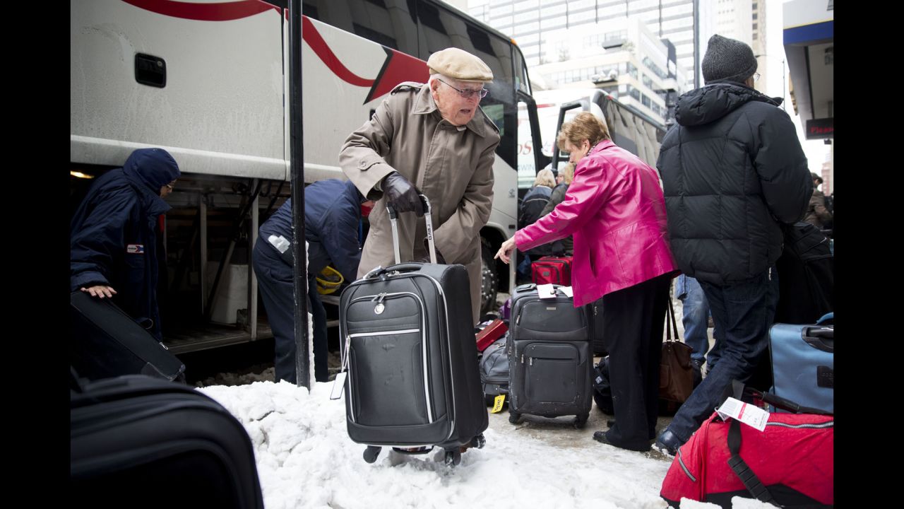 Passengers unload their luggage at Chicago's Union Station after their Amtrak train became stuck in snow drifts on Tuesday, January 7.