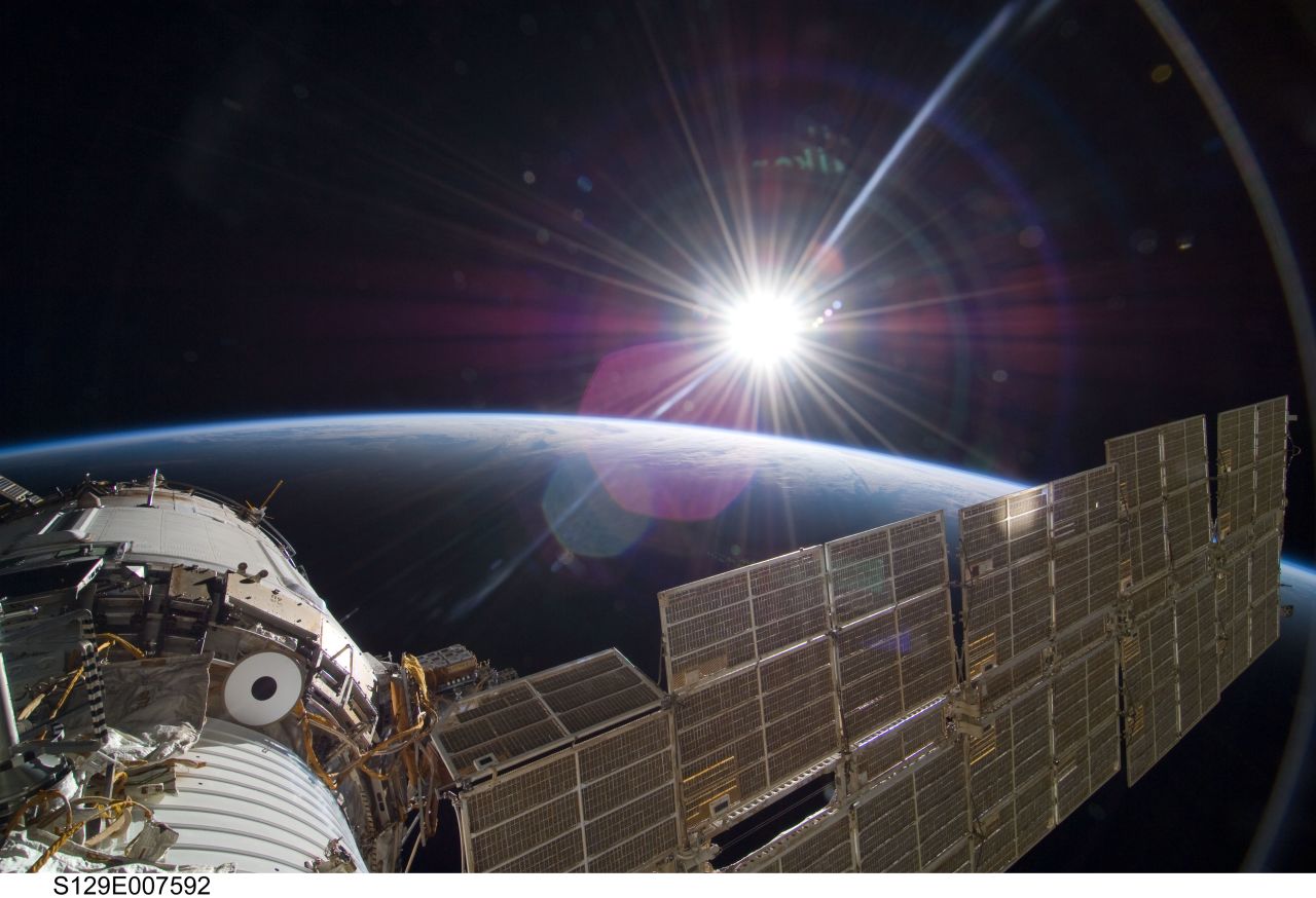 The bright sun greets the International Space Station from the Russian section of the orbital outpost, photographed by one of the STS-129 crew members.