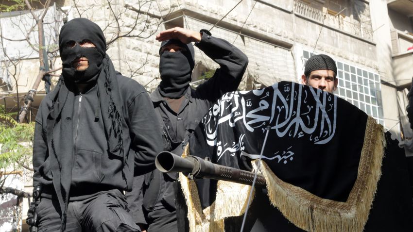 This file photo shows members of jihadist group al-Nusra Front in a parade in Syria in October 2013.