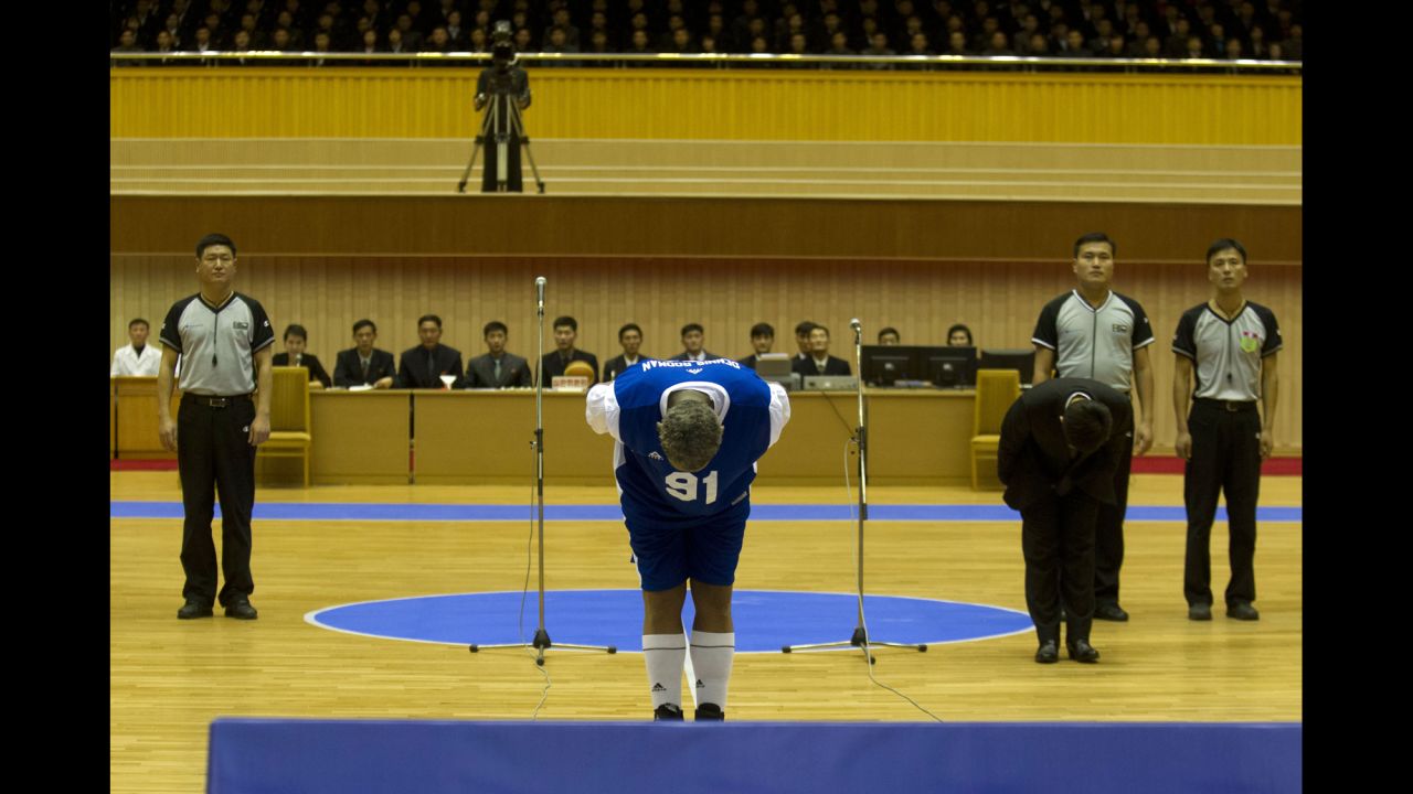 Rodman bows to Kim, seated above in the stands, before the basketball game on January 8.