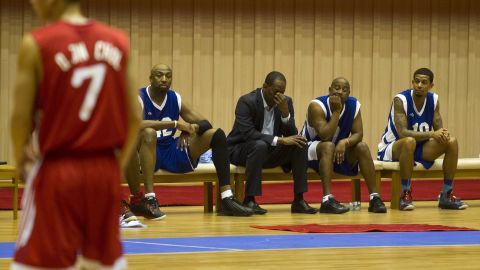 Former NBA star Eric "Sleepy" Floyd, center, sits with fellow American basketball players.