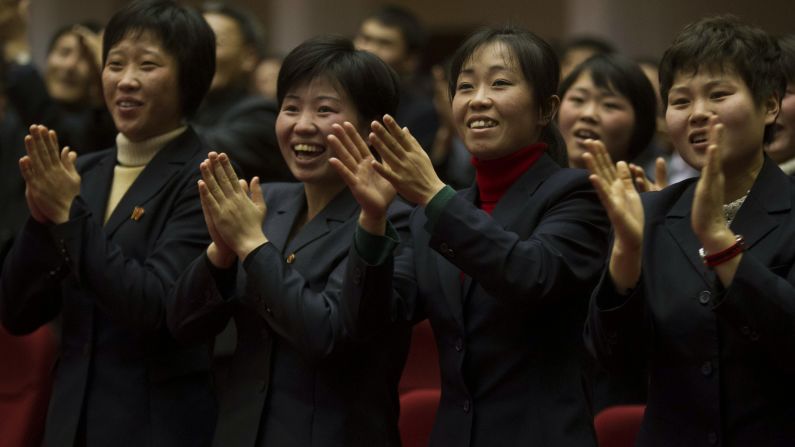 North Koreans applaud at the start of the game.