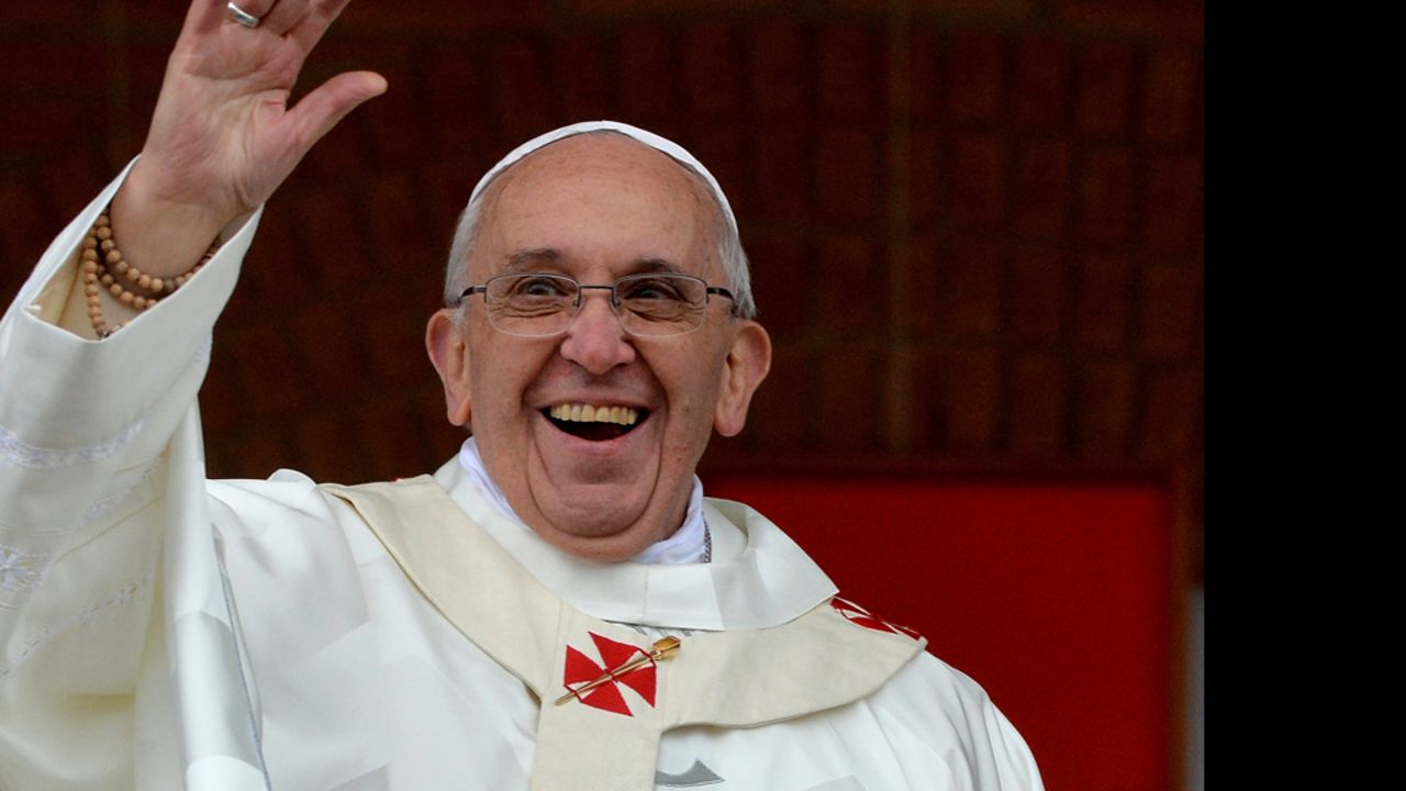 Pope Francis waves to the crowd gathering outside the Basilica of Our Lady of Aparecida, Brazil's most revered Catholic shrine, after he celebrated mass there, in Aparecida, Sao Paulo State, on July 24, 2013. Pope Francis warned Catholics on Wednesday against "ephemeral idols" like money at his first public mass in his native Latin America as huge crowds lined the streets to cheer him. The first Latin American and Jesuit pontiff visited Aparecida to lead his first big mass since arriving in the country for a week-long visit of which highlight is the huge five-day Catholic gathering World Youth Day.    AFP PHOTO/LUCA ZENNARO/POOL        (Photo credit should read LUCA ZENNARO/AFP/Getty Images)