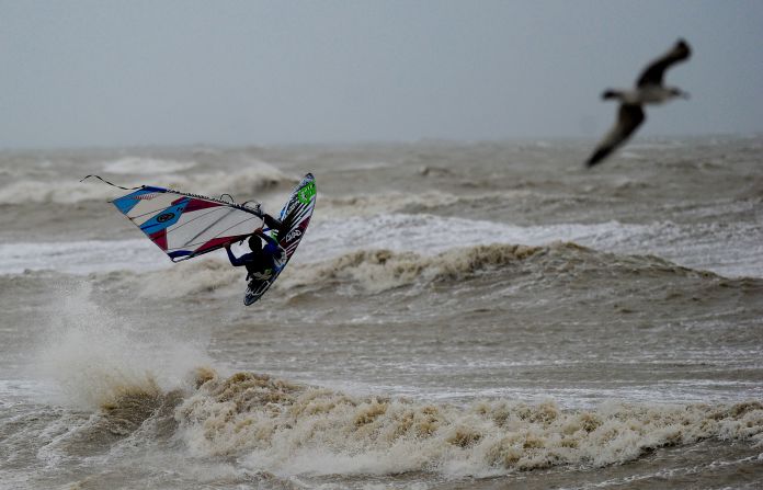 Off English shores, a windsurfer braves the elements. Gale force winds and a tidal surge caused widespread flooding in coastal areas of England and Wales.