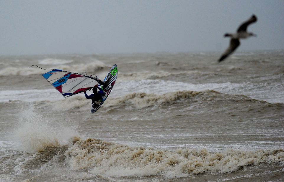 Off English shores, a windsurfer braves the elements. Gale force winds and a tidal surge caused widespread flooding in coastal areas of England and Wales.