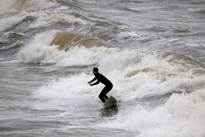 These waves may be tiddlers for the professional surfers but rough seas off Porthcawl in Wales still attract a local pleasure seeker.