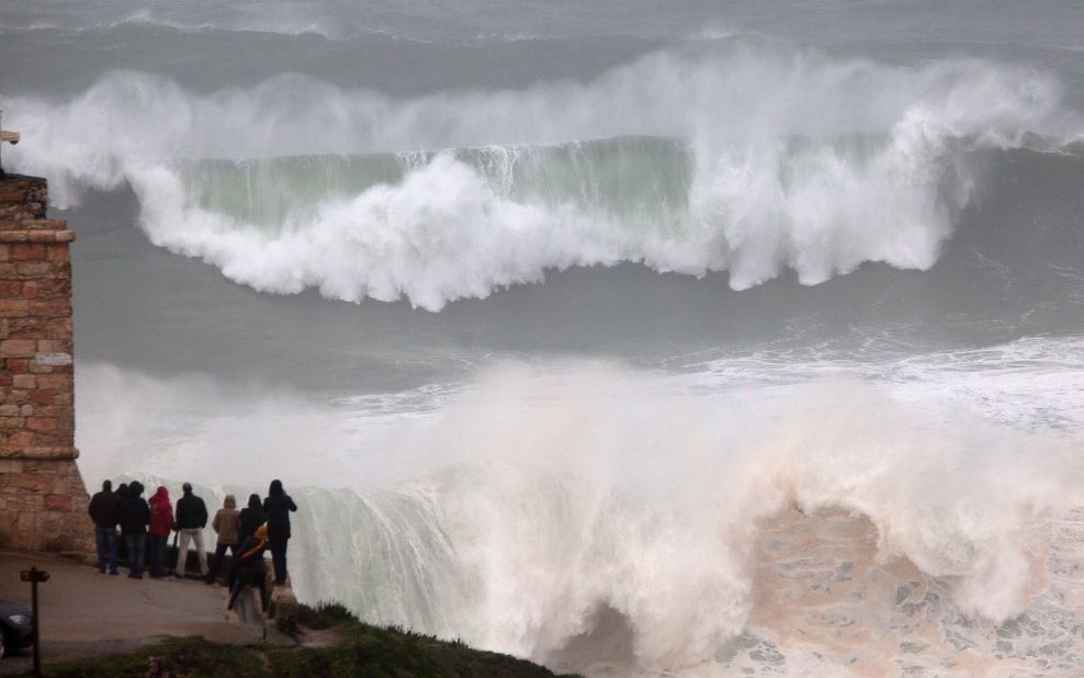 Last year surfing hot spot Praia do Norte in Nazare, Portugal was also graced by mighty waves but this crowd sensibly decided to stay on the shore as the surf broke.