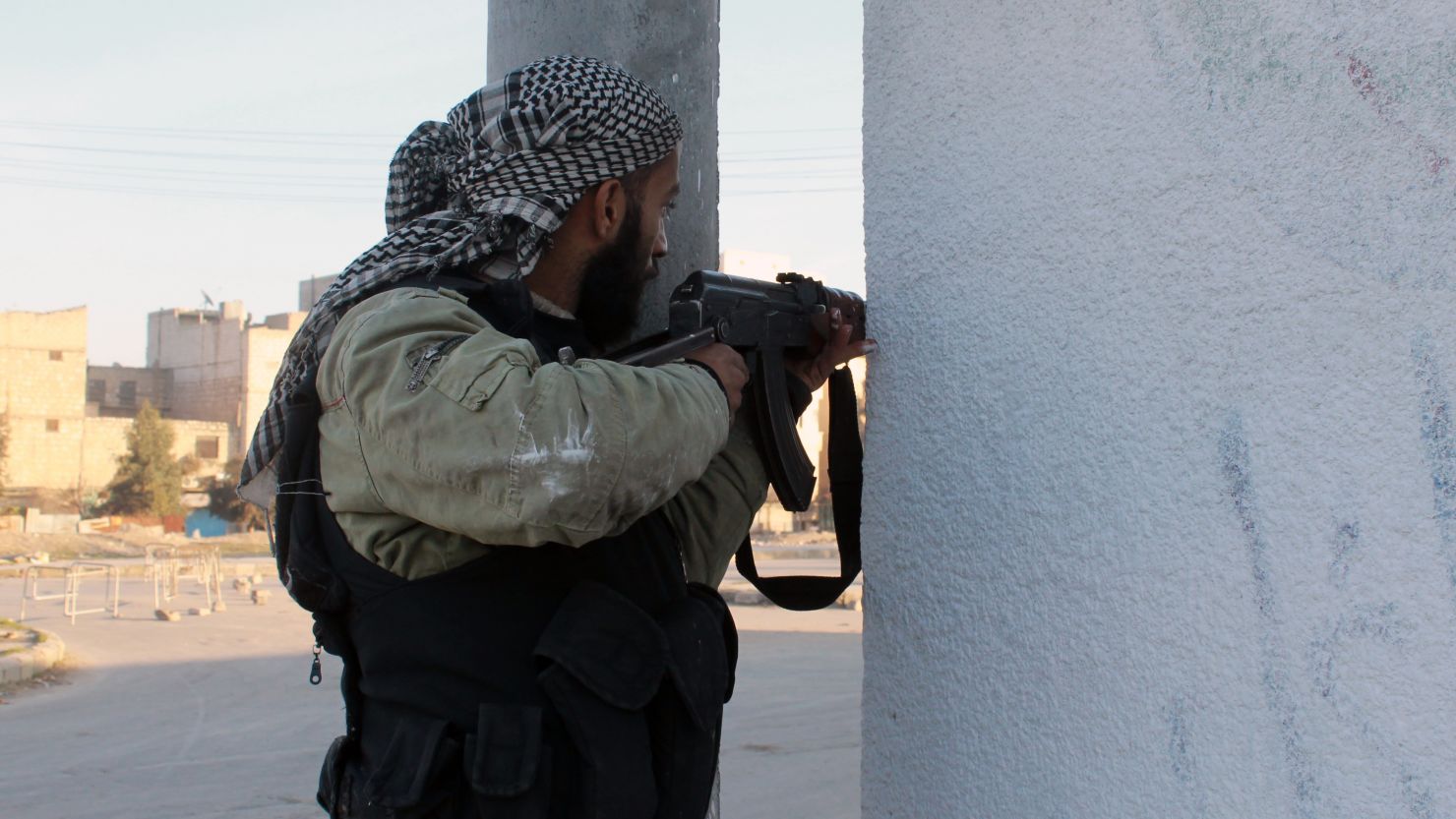 An opposition fighter guards a position in the northern Syrian city of Aleppo on January 7, 2014.