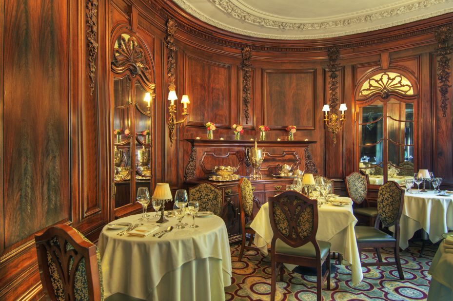 The home's paneled oval dining room provides an intimate dining experience.