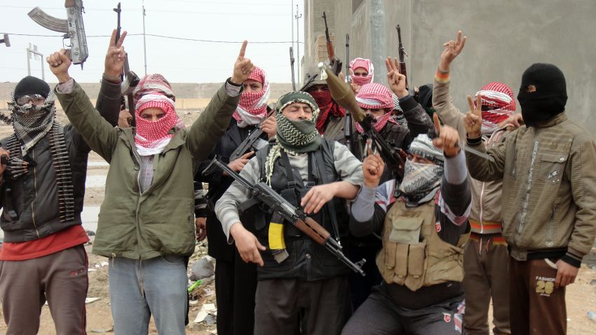 Iraqi men from local tribes brandish their weapons as they pose for a photograph in the city of Falluja, west of the capital Baghdad, on January 5, 2014.
