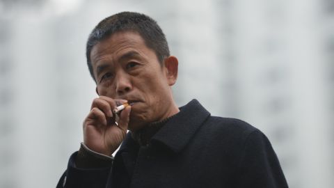A man smokes a cigarette on a street in Shanghai on January 8.