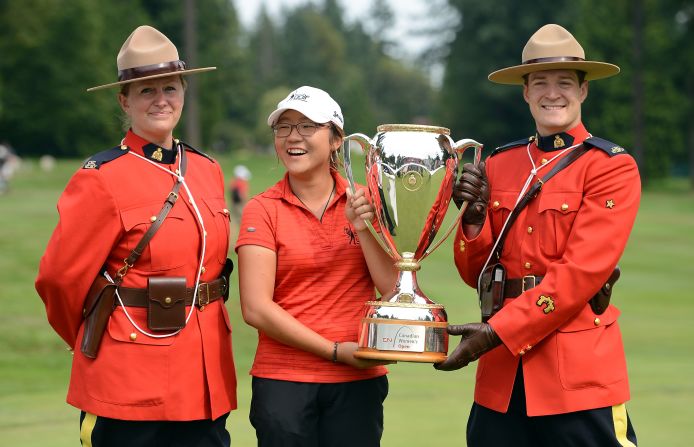 Ko is flanked by an honor guard of Royal Canadian Mounties after her record-breaking win at the 2012  CN Canadian Open. At just 15 years and four months, the New Zealander became the youngest winner of an LPGA Tour event.