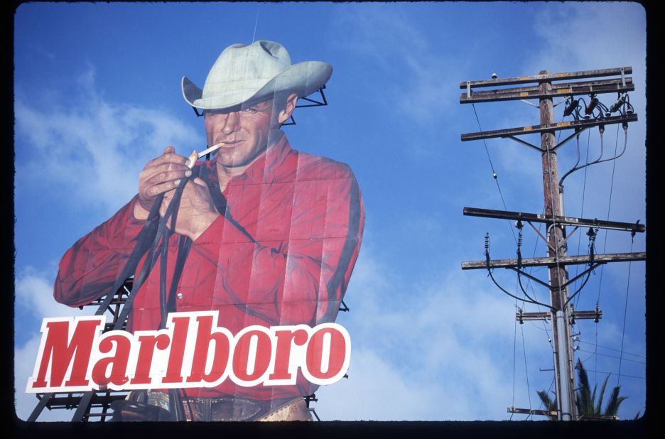 A billboard advertises Marlboro cigarettes. The rugged "Marlboro Man" was a staple of the brand's marketing.