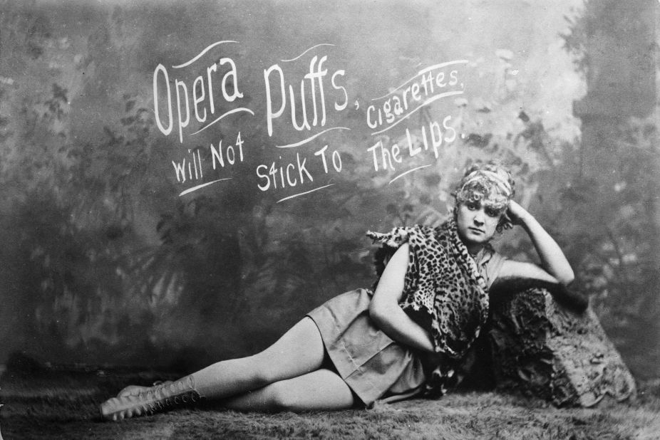 A model is seen lying down in an advertisement for Opera Puffs Cigarettes.