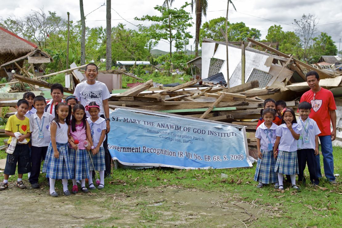 Fr. Berhabe Tujaha (left) with some of the pupils of St. Mary's elementary school, which was destroyed by Typhoon Haiyan.