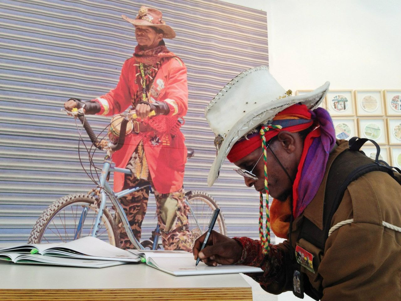 Asher Tafara signing the "Bicycle Portraits" book he appears in.