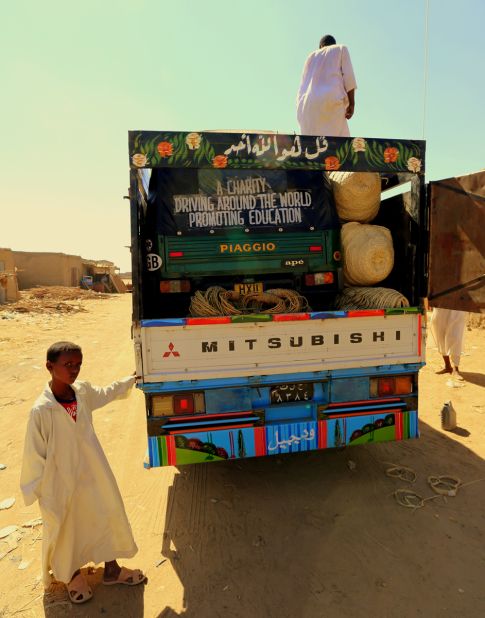 Struggling with barren sandy roads, the tuk tuk is loaded onto a truck in Sudan.