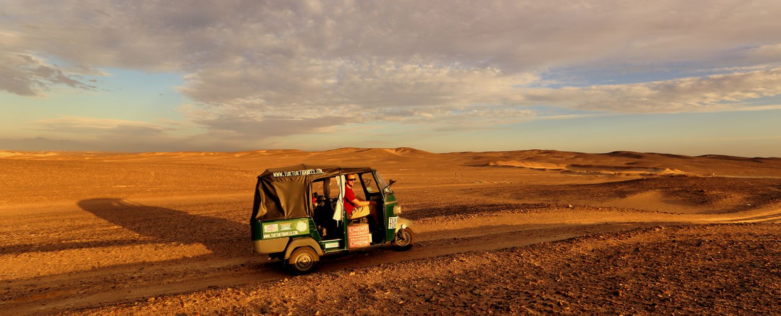 Using makeshift wood planks and spades, Nick Gough and Richard Sears learned how to free their tuk tuk when it got stuck in the sand. Egypt was one of the toughest countries to bring a tuk tuk into, says Gough. 