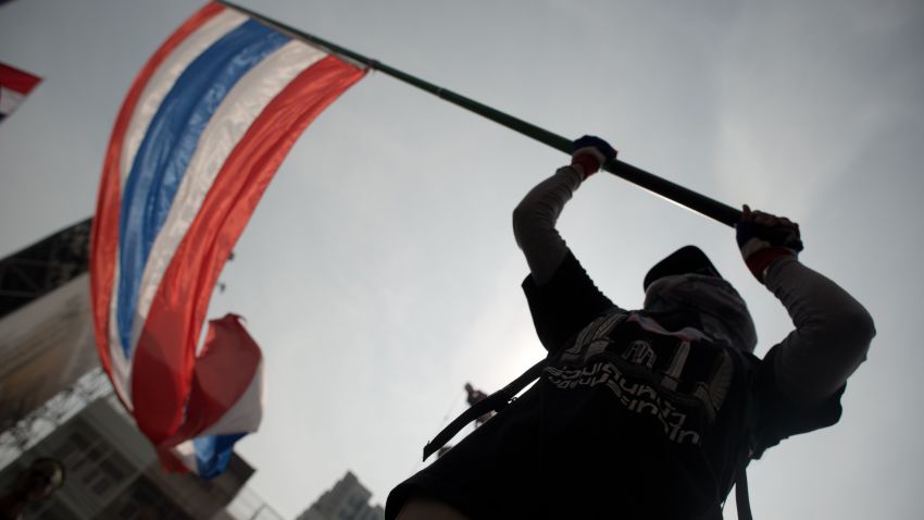 A Thai anti government protester waves the national flag during a rally in Bangkok on January 7, 2014. Demonstrators, who are seeking to curb the political dominance of Prime Minister Yingluck Shinawatra's billionaire family, say they will 'shut down' Bangkok from January 13. AFP PHOTO / NICOLAS ASFOURI (Photo credit should read NICOLAS ASFOURI/AFP/Getty Images)