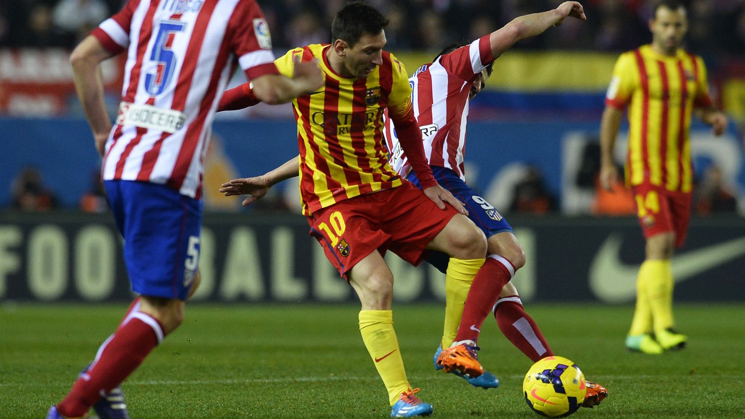 Lionel Messi tangles with former teammate David Villa during the 0-0 draw at the Vicente Calderon Stadium on Saturday.