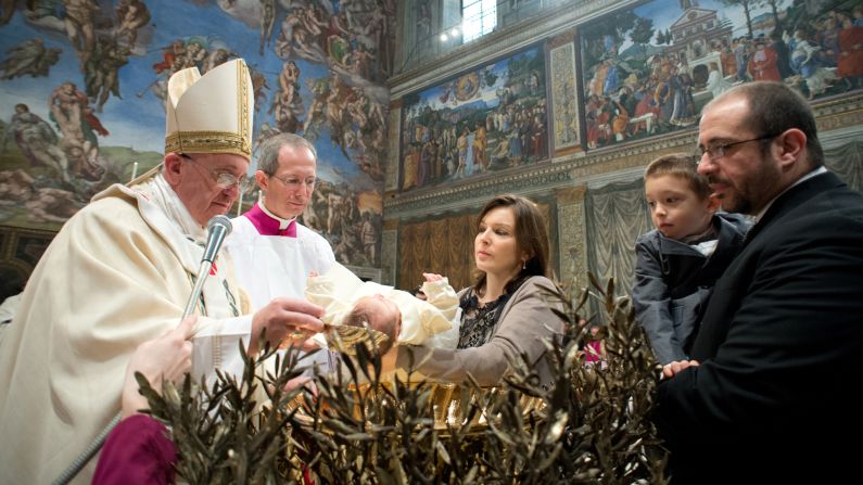 The Pope baptizes one of the 32 children.