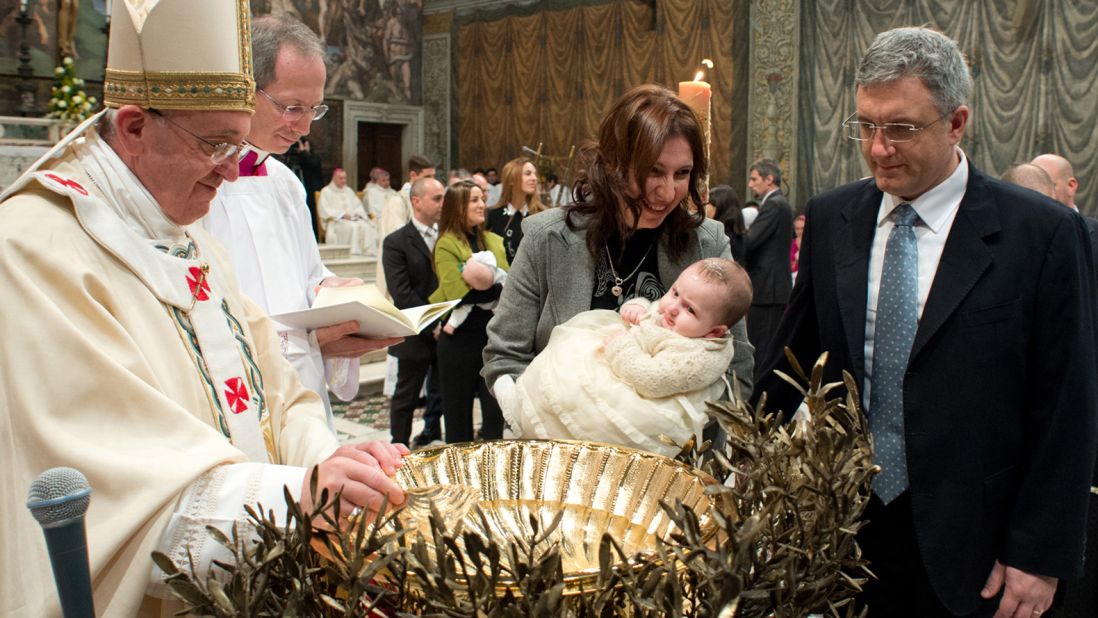 A child is baptized during the ceremony.
