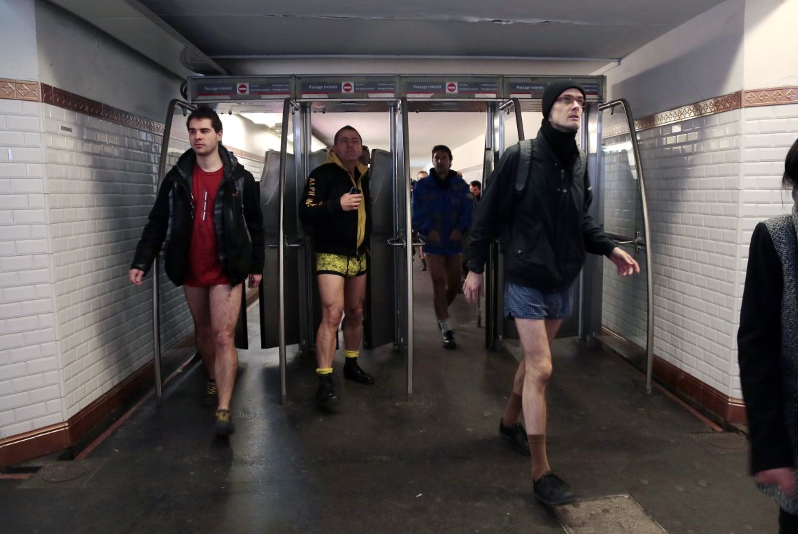 Pantsless patrons walk through a subway station in Paris.
