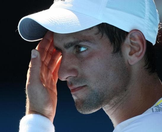 Novak Djokovic contemplates his fate ahead of his retirement with heat exhaustion in a quarterfinal match against Andy Roddick at the Australian Open in 2009.