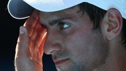 Djokovic contemplates his fate ahead of his retirement with heat exhaustion in a quarterfinal match against Andy Roddick at the Australian Open in 2009.