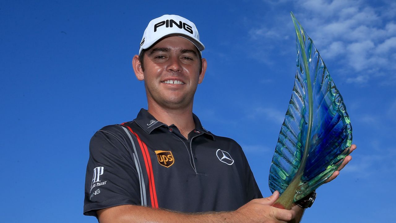 Louis Oosthuzen shows off the winning trophy after the South African won the European Tour event in Durban.