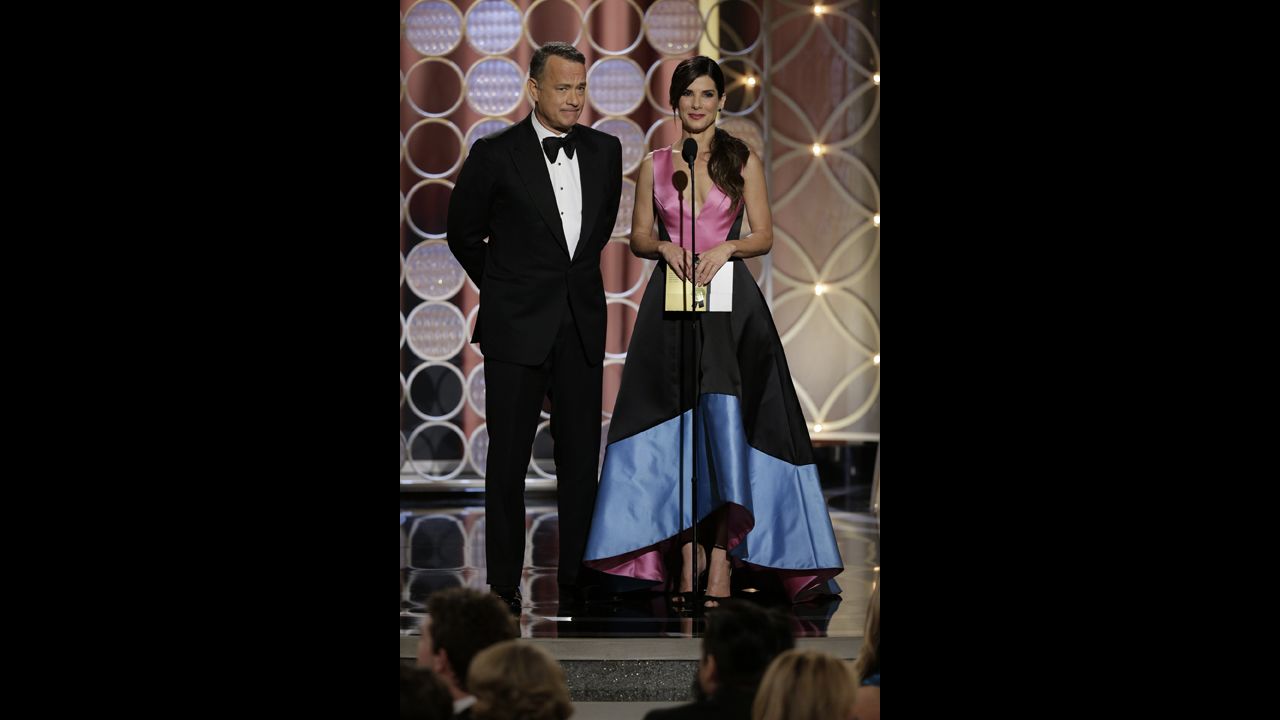 Tom Hanks and Sandra Bullock present the award for best supporting actress in a motion picture. Jennifer Lawrence won for her role in the movie "American Hustle."