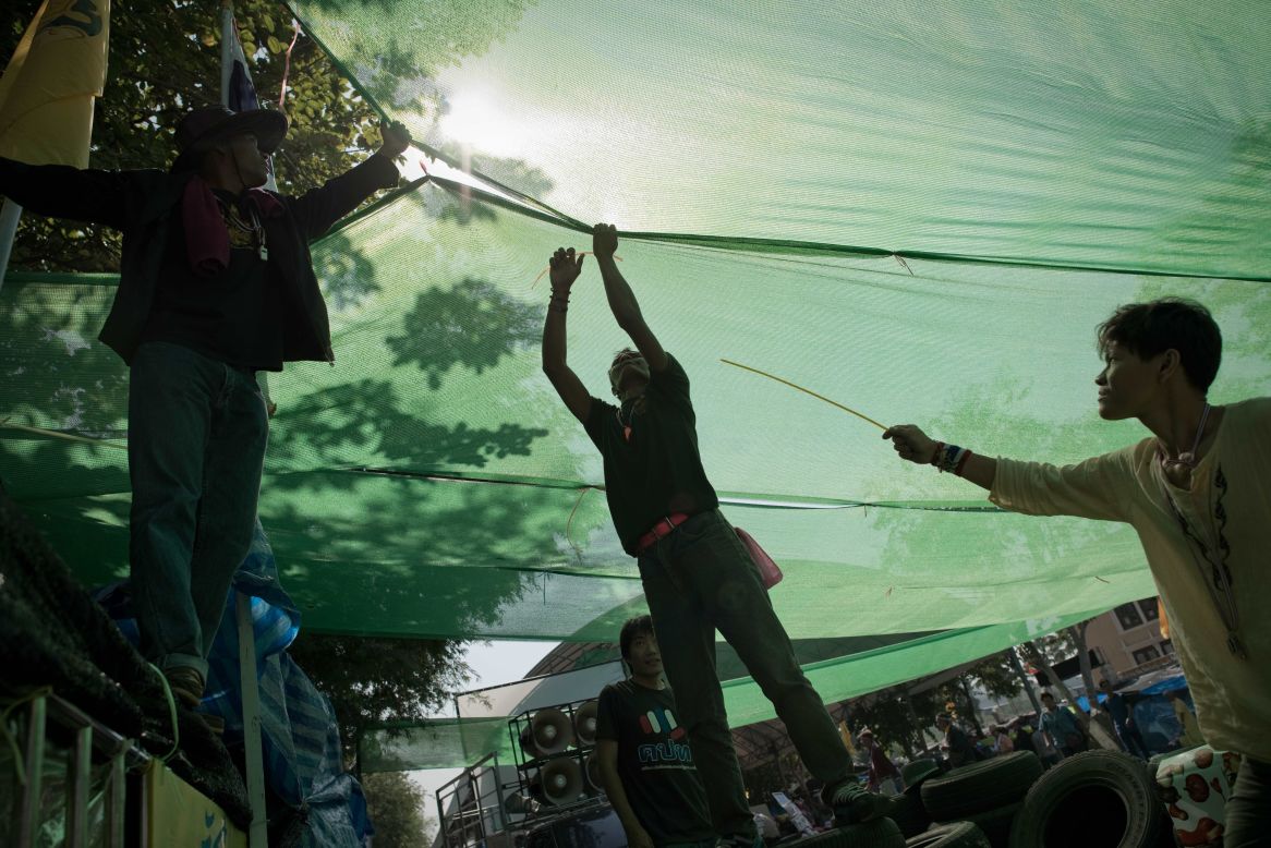 Thai anti-government protesters set up a spot with shade on a street outside the Government house in Bangkok on January 12, 2014.