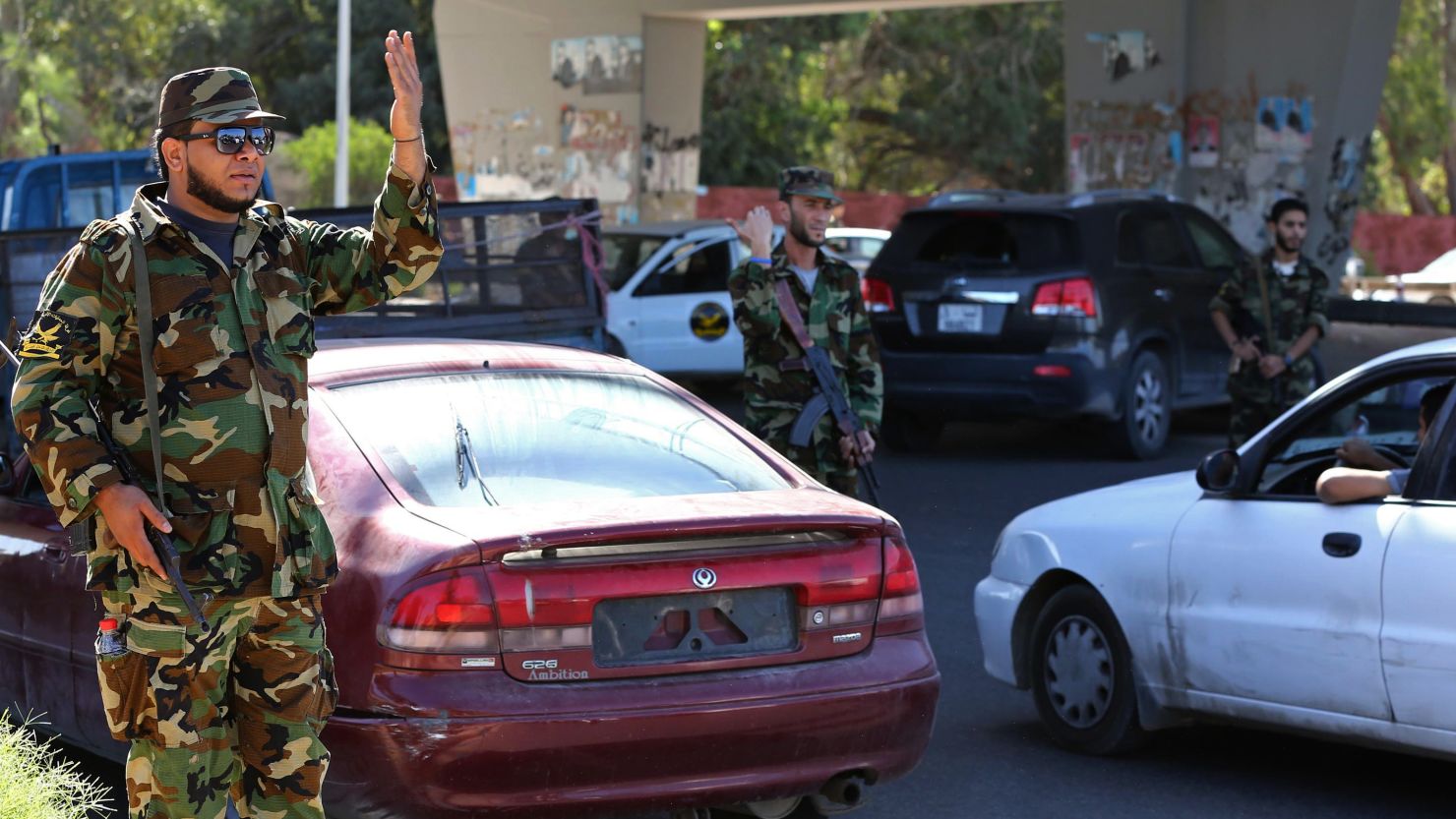 Libyan military personnel man a checkpoint set up to try to secure the capital, Tripoli, on October 20, 2013.