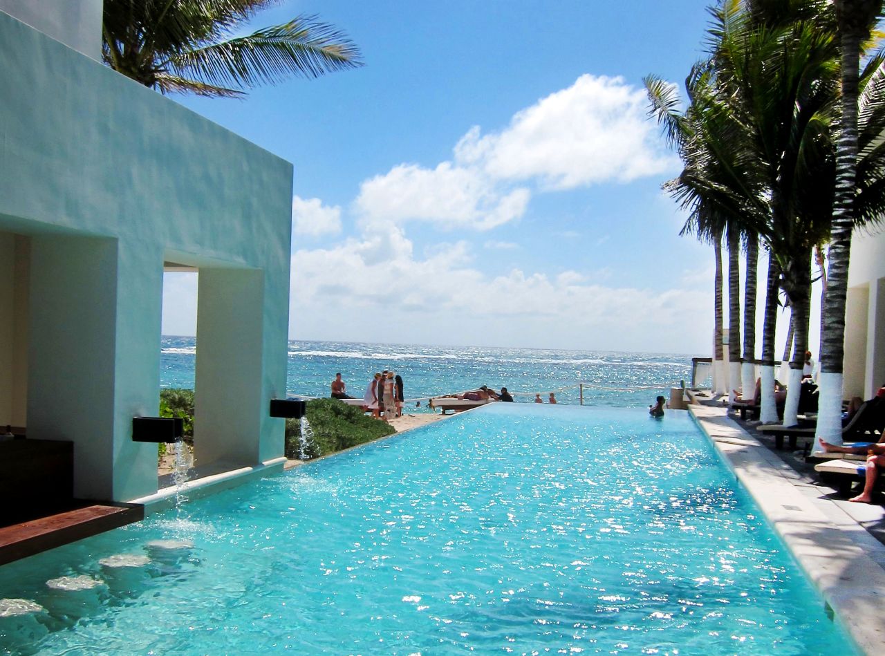 An infinity pool and a swim-up sushi bar add to the sleek feel of Oasis Tulum's recently renovated exterior. 