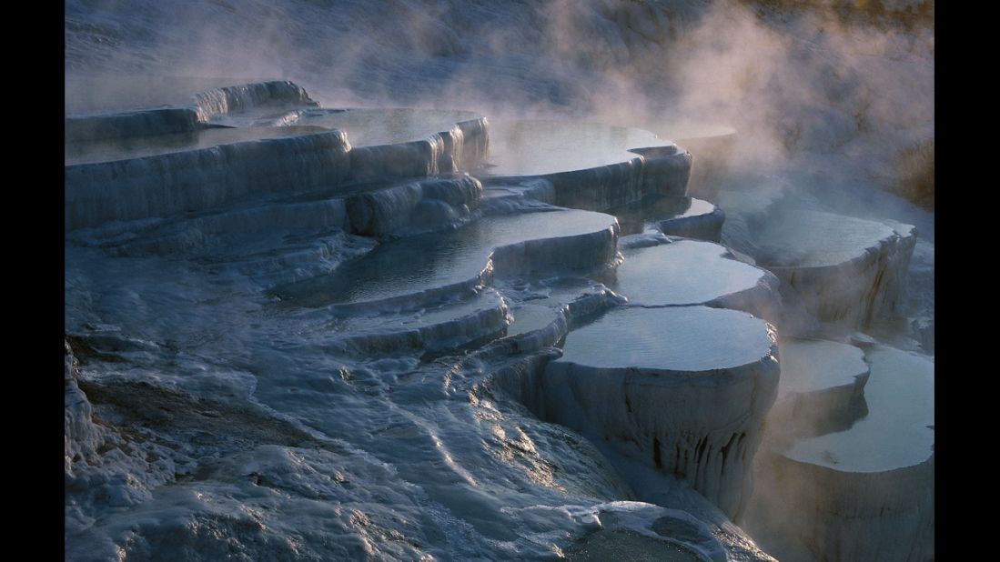 The frozen-looking landscape in Pamukkale, Turkey, is actually the result of calcium carbonate deposits from 17 natural hot springs accumulating over thousands of years. 