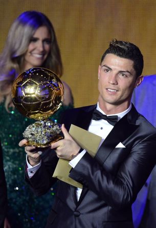 Cristiano Ronaldo raises the Ballon d'Or, after being crowned FIFA's best for the second time in his career. 