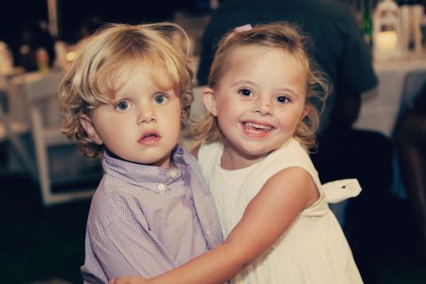 Ellie poses with her younger brother at a recent wedding.