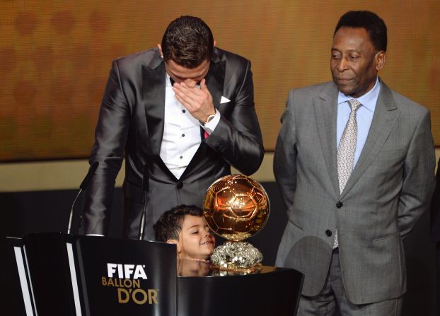 While the Portuguese star is overcome by emotion, his son Cristiano Ronaldo Jr cannot hide his glee at his father's prize. 
