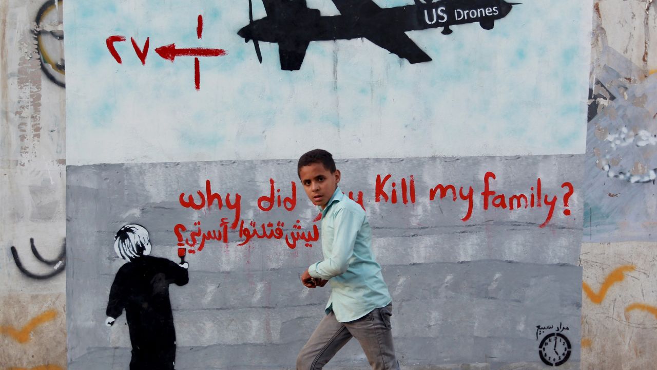 A Yemeni boy walks past a mural of a U.S. drone on December 13, 2013 in the capital Sanaa.