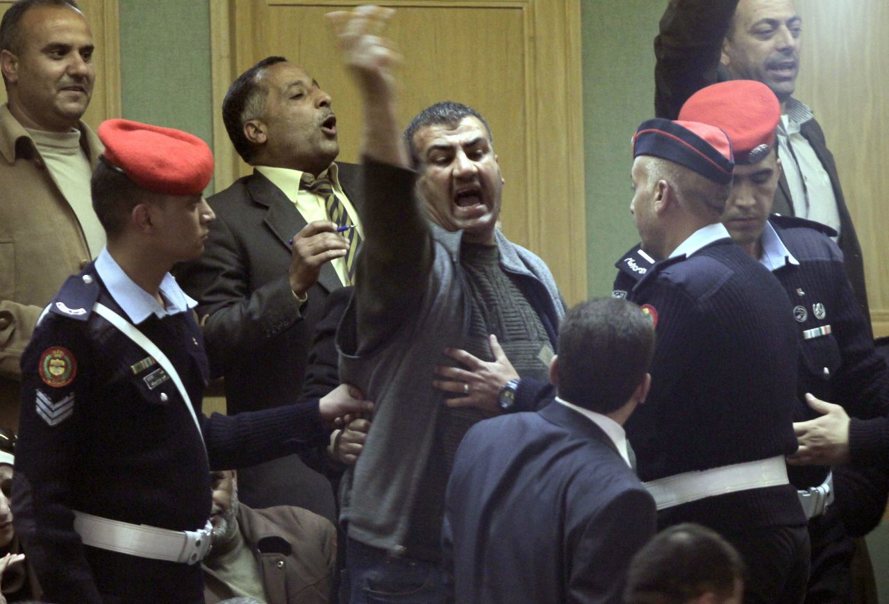 Jordanian police attempt to removes protesters opposed to Jordan's Prime Minister Abdullah Nsur after he addressed parliament in Amman, and winning a vote of confidence, on April 23, 2013.