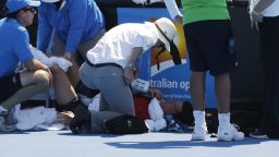 Frank Dancevic receives medical attention after fainting during his first round match.