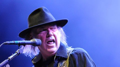 Canadian guitarist Neil Young performs on stage at the Vieilles Charrues festival on July 20, 2013, in France. Young recently pulled his music from music-streaming platforms, citing poor quality.