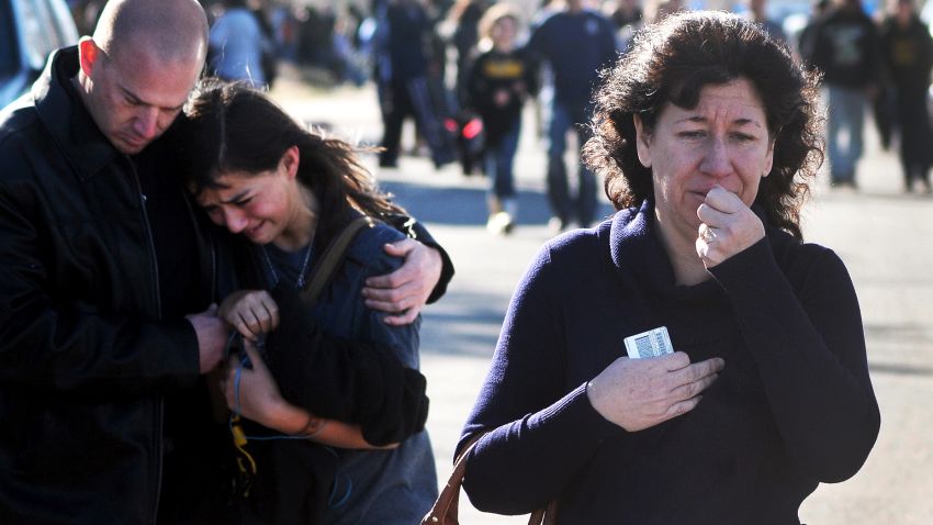 A woman waits at a staging ground area where families are being reunited with Berrendo Middle School students after a shooting at the school, Tuesday, Jan. 14, 2014, in Roswell, N.M. A shooter opened fire at the middle school, injuring at least two students before being taken into custody. Roswell police said the school was placed on lockdown, and the suspected shooter was arrested. (AP Photo/Roswell Daily Record, Mark Wilson)