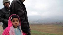 Syrian refugees newly arrived in Turkey look at the Syrian border from the Turkish side on January 14, 2014 in Kilis.