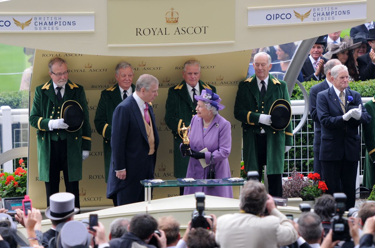 The British monarch receives the winning trophy for the Ascot Gold Cup last year after her horse Estimate won the prestigious race. 