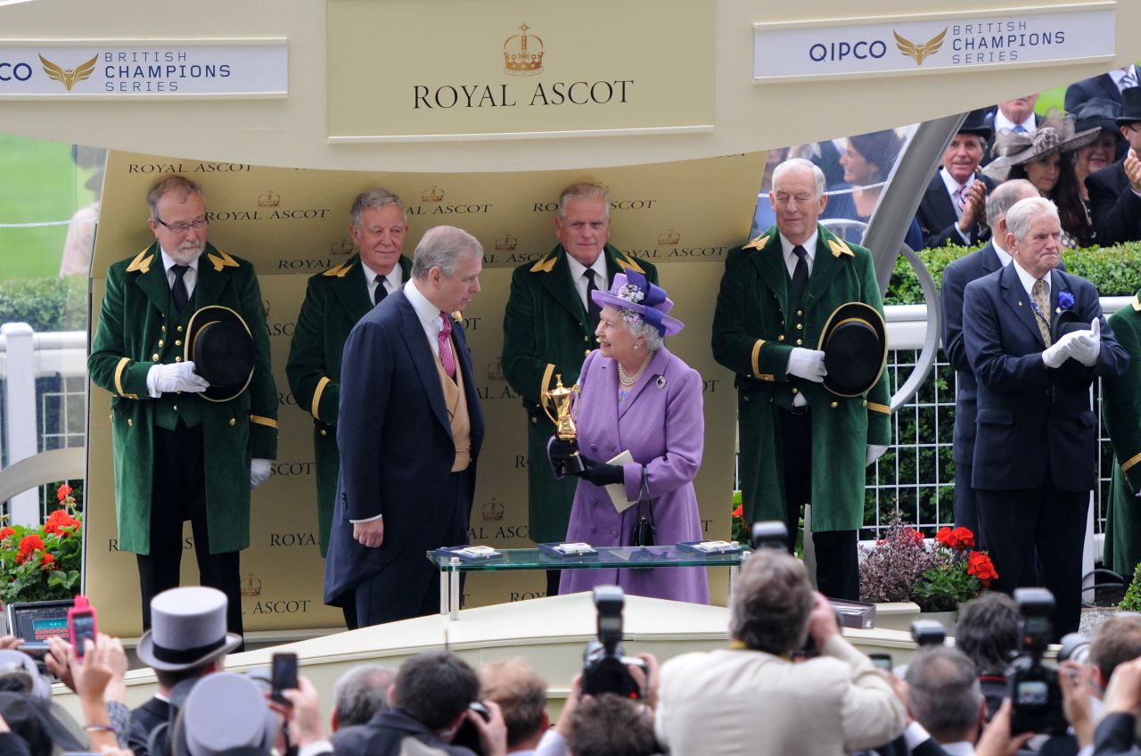 The British monarch receives the winning trophy for the Ascot Gold Cup last year after her horse Estimate won the prestigious race.