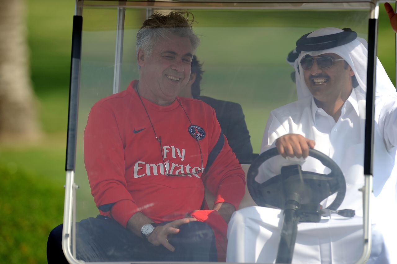 Paris Saint-Germain's coach Carlo Ancelotti rides in a golf buggy with Qatari Crown Prince Sheikh Tamim bin Hamad al-Thani, the French football club's owner. 