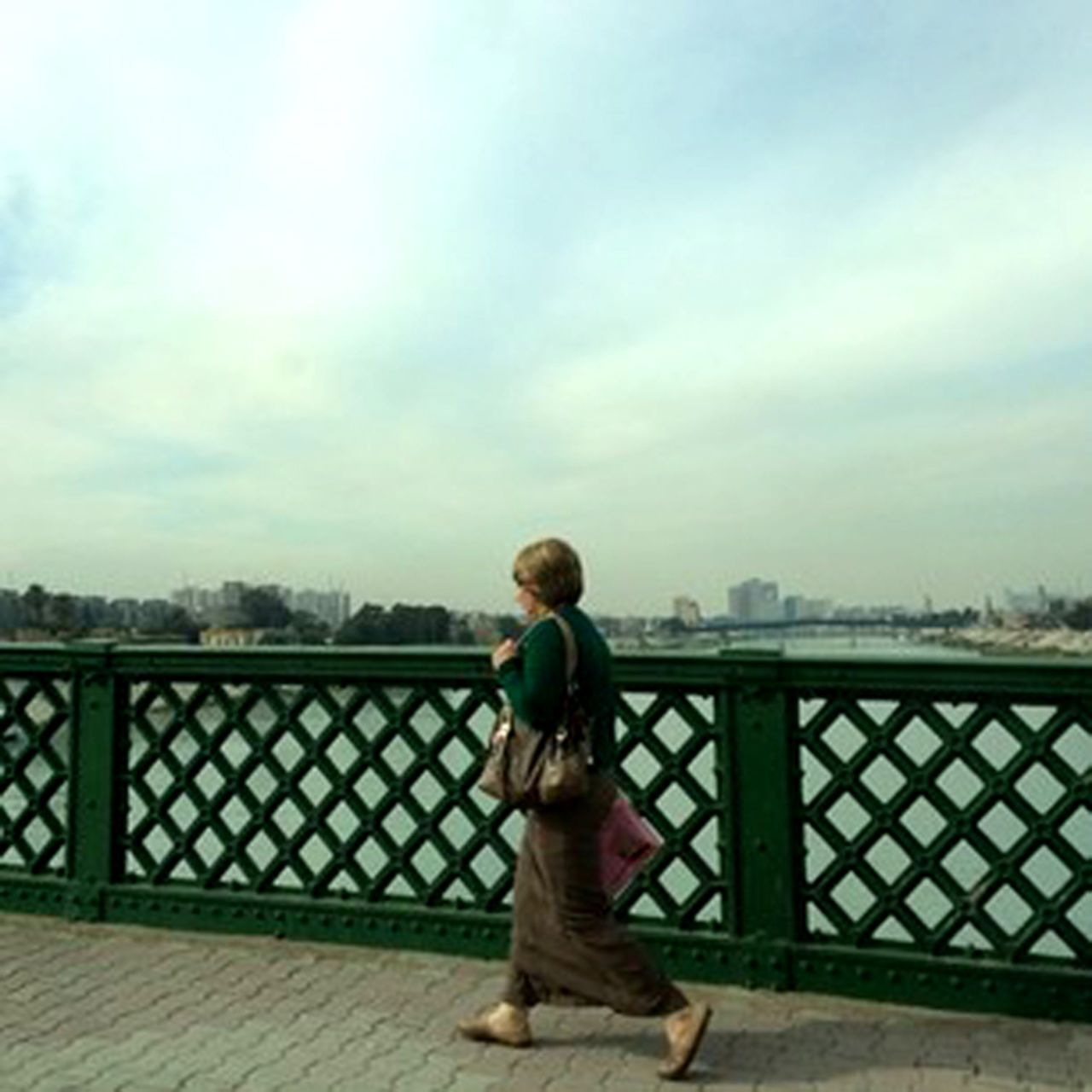 In this image taken on January 15, a woman walks through central Baghdad, Iraq, crossing a bridge over the Tigris River. CNN's Michael Holmes is in the Iraqi capital for the first time in two years. Click through to see images from Holmes and CNN producer Hamdi Alkhshali.