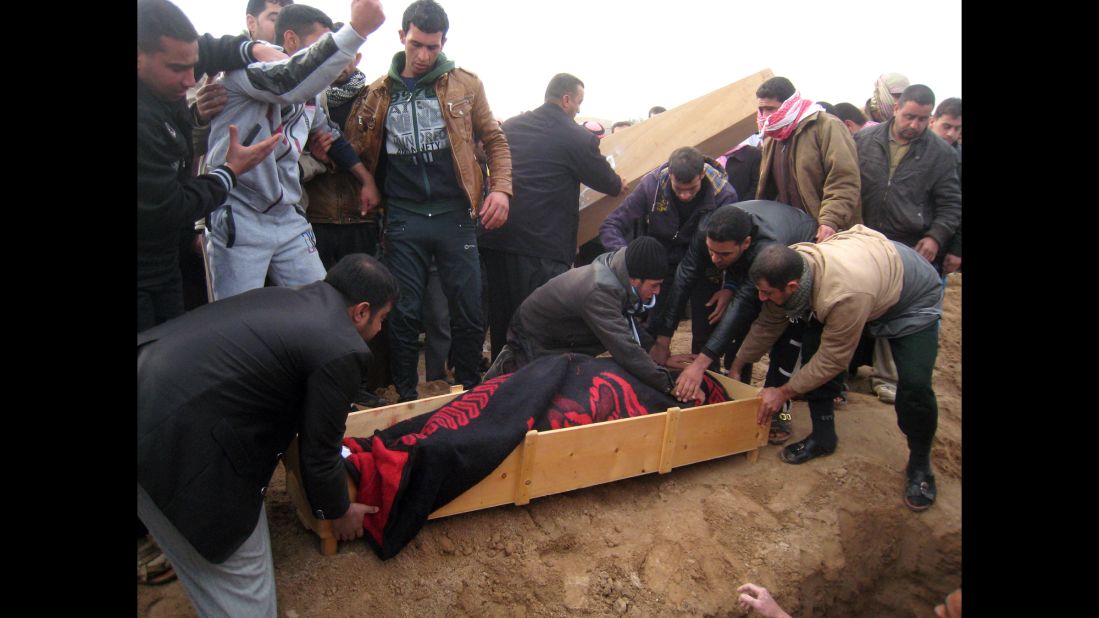 Mourners prepare to bury a man killed in a mortar attack in Falluja, Iraq, on Tuesday, January 14. Since the beginning of January, violence in the city just west of Baghdad has increased as Sunni tribesmen and members of the Islamic State of Iraq and Syria took over the city.